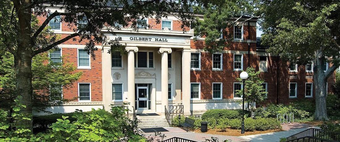 Gilbert Hall - Brick building with classic style columns at the front entrance