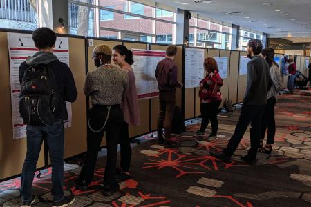 Students gathered around looking at posters