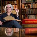 Kim Waters in front of bookcase